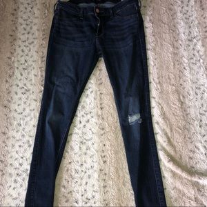 Dark blue Hollister skinny jeans with knee rip